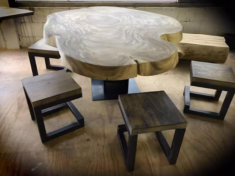 Houten boomstamblad tafel met een stalen onderstel en houten stoelen met stalen onderstellen Houten boomstamblad tafel met een stalen onderstel en houten stoelen met stalen onderstellen